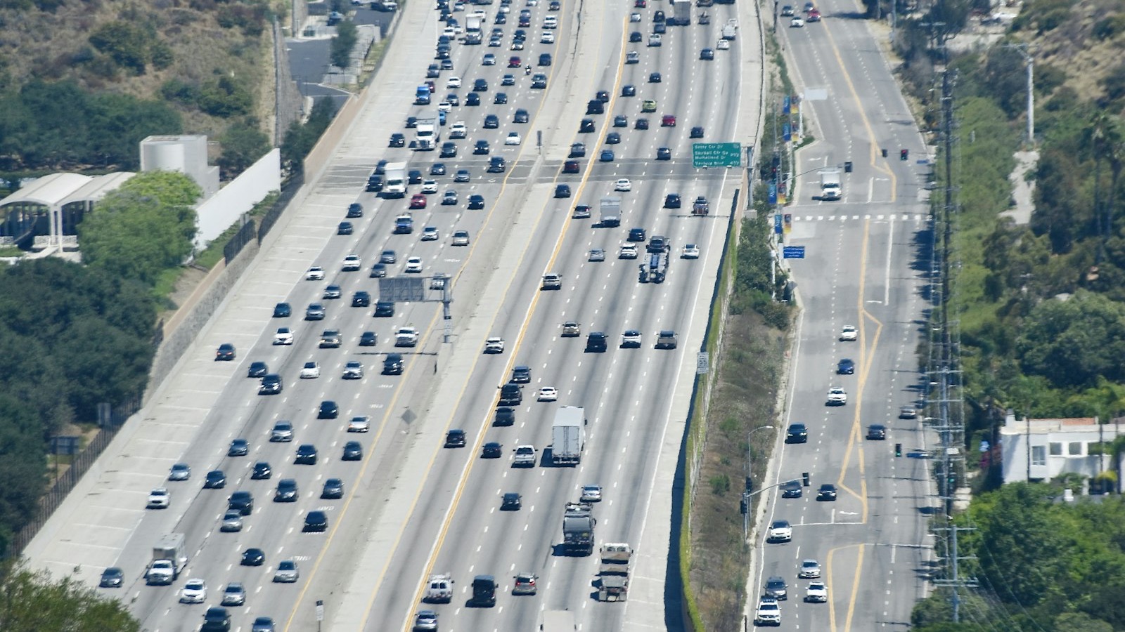 Heavy traffic moving across several lanes of a divided highway